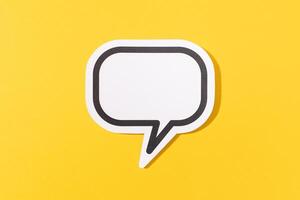 Blank Speech Bubble isolated on yellow background. Mock up template photo