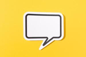 Blank Speech Bubble isolated on yellow background. Mock up template photo