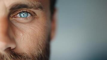 Close-Up Portrait of a Man With Intense Eyes and a Beard in Natural Light photo
