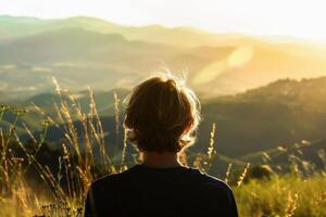 A person with their back to the camera gazing out at a scenic view with soft light outlining their figure. AI generate photo