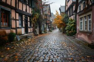 An empty cobblestone road in a historic town with old half timbered houses. AI generate photo