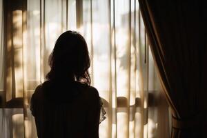 Silhouette of a woman against a window with sheer curtains softly filtering the sunlight. AI generate photo
