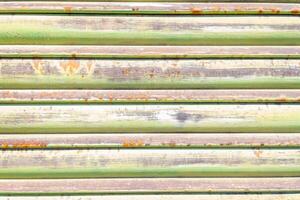 close up view of an old, rusted metal shutter with traces of green paint, textured background photo