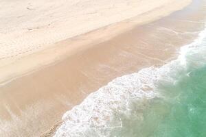 aerial drone top view of a beach, summer landscape. Drone photography. Turquoise sea water and clear sand. photo