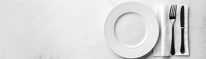 A minimalist, high-key setup with a plate, knife, and fork on a white napkin, set against a crisp, white background, broad empty space on the right for promotional text. photo