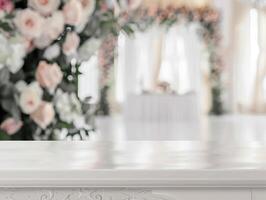 An elegant wedding venue with beautiful floral decorations and a white draped altar, captured in soft focus. photo