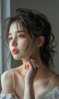 A close-up portrait of an elegant woman with wavy hair, illuminated by natural light, showcasing her glowing skin and red lips. photo