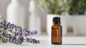 Essential oil bottle with a lavender plant in the background. photo