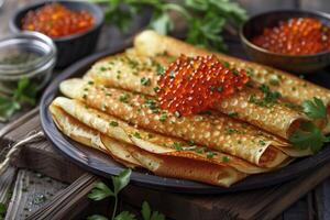 A plate of pancakes with a garnish of red caviar and parsley photo