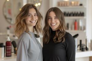 Two women are smiling and posing for a picture in a hair salon photo