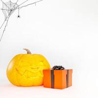 Halloween background concept with Halloween pumpkin, orange gift box and spider web on white background and copy space. 3d render. photo