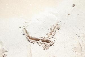 Heart in the sand on the beach. The concept of love. photo