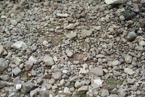 Rocky ground texture, closeup of stone floor surface background. photo