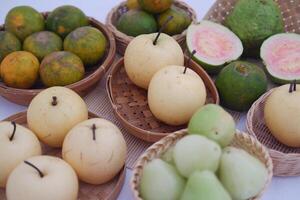 various kinds of fruit in basket on white background. photo