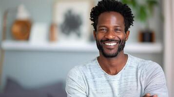 Smiling Man in Gray Sweater Sitting Comfortably in Cozy Indoor Space photo