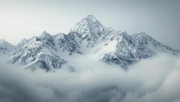 Snow-Capped Mountains Amidst Fog in Early Morning Light photo
