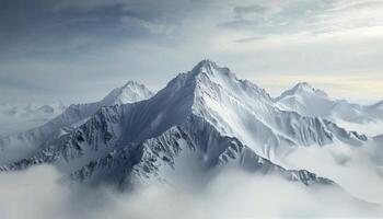 Snow-Capped Mountains Amidst Fog in Early Morning Light photo