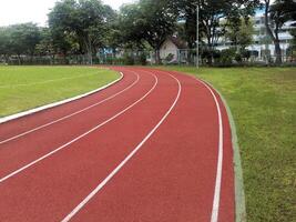 The running track inside a football stadium is usually a circular pathway surrounding the field photo