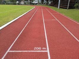 The running track inside a football stadium is usually a circular pathway surrounding the field photo