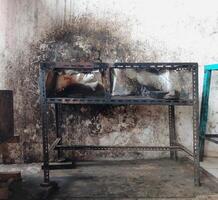 The iron table that houses the trader's stove looks dirty, the table has been used for annual trading photo