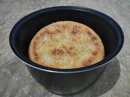 Photo of hardened rice, dry rice on magic com, the rice is dry and then hardened until it turns brownish. burnt rice, crusty rice