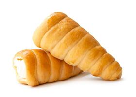 Side view of brown puff pastry cream horns in stack isolated on white background with clipping path photo