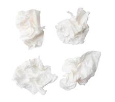 Top view set of screwed or crumpled white tissue paper balls after use isolated on white background with clipping path photo