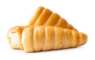 Side view of puff pastry cream horns in stack isolated on white background with clipping path photo