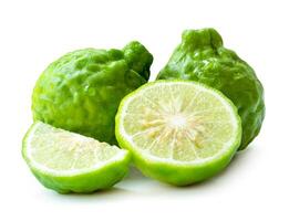 Front view of fresh green bergamot fruit with half and slice or quarter in stack isolated on white background with clipping path photo