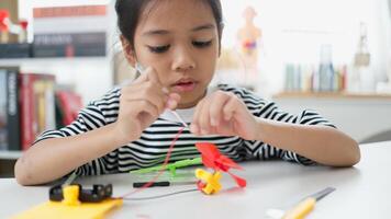 STEM education concept. Asian students learn at home with STEM toys, mathematics engineering science technology computer code in robotics for kids' concepts. photo