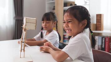 STEM education concept. Asian students learn at home with STEM toys, mathematics engineering science technology computer code in robotics for kids' concepts. photo