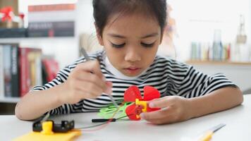STEM education concept. Asian students learn at home with STEM toys, mathematics engineering science technology computer code in robotics for kids' concepts. photo