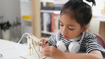 STEM education concept. Asian students learn at home with STEM toys, mathematics engineering science technology computer code in robotics for kids' concepts. photo