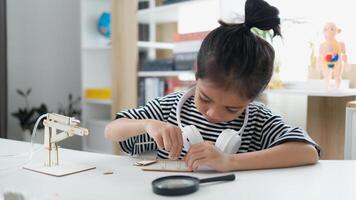 STEM education concept. Asian students learn at home with STEM toys, mathematics engineering science technology computer code in robotics for kids' concepts. photo