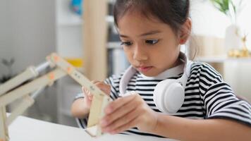STEM education concept. Asian students learn at home with STEM toys, mathematics engineering science technology computer code in robotics for kids' concepts. photo