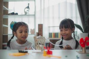 STEM education concept. Asian students learn at home with STEM toys, mathematics engineering science technology computer code in robotics for kids' concepts. photo