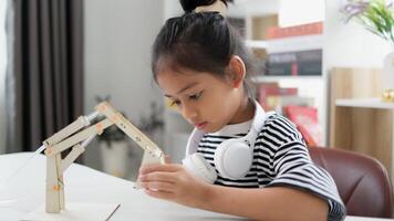 STEM education concept. Asian students learn at home with STEM toys, mathematics engineering science technology computer code in robotics for kids' concepts. photo
