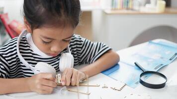 STEM education concept. Asian students learn at home with STEM toys, mathematics engineering science technology computer code in robotics for kids' concepts. photo