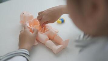 Asian girl playing with anatomical dolls in a doctor game, Learn through play about internal organs with anatomical dolls at home. Children want to be a doctor. photo