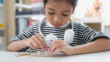 STEM education concept. Asian students learn at home with STEM toys, mathematics engineering science technology computer code in robotics for kids' concepts. photo