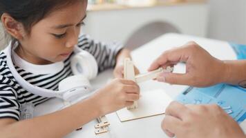 STEM education concept. Asian students learn at home with STEM toys, mathematics engineering science technology computer code in robotics for kids' concepts. photo