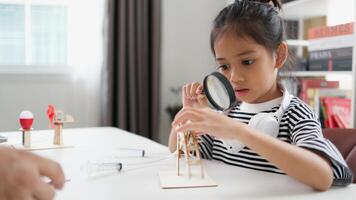 STEM education concept. Asian students learn at home with STEM toys, mathematics engineering science technology computer code in robotics for kids' concepts. photo