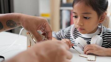 STEM education concept. Asian students learn at home with STEM toys, mathematics engineering science technology computer code in robotics for kids' concepts. photo