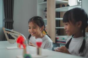 STEM education concept. Asian students learn at home with STEM toys, mathematics engineering science technology computer code in robotics for kids' concepts. photo