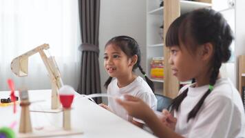 STEM education concept. Asian students learn at home with STEM toys, mathematics engineering science technology computer code in robotics for kids' concepts. photo