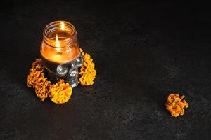 Skull with marigold flowers wreath on black background. Dia de los muertos day or day of the dead photo