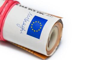 Concept of many euros a pile of rolled 50-euro bills lying on a white background photo