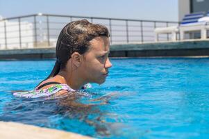 A portrait of an 10 year old girl in an outside swimming pool photo