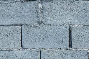 old gray cement background with cinder block wall photo