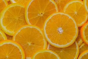 oranges cut into slices and laid out on the table as a food background 10 photo